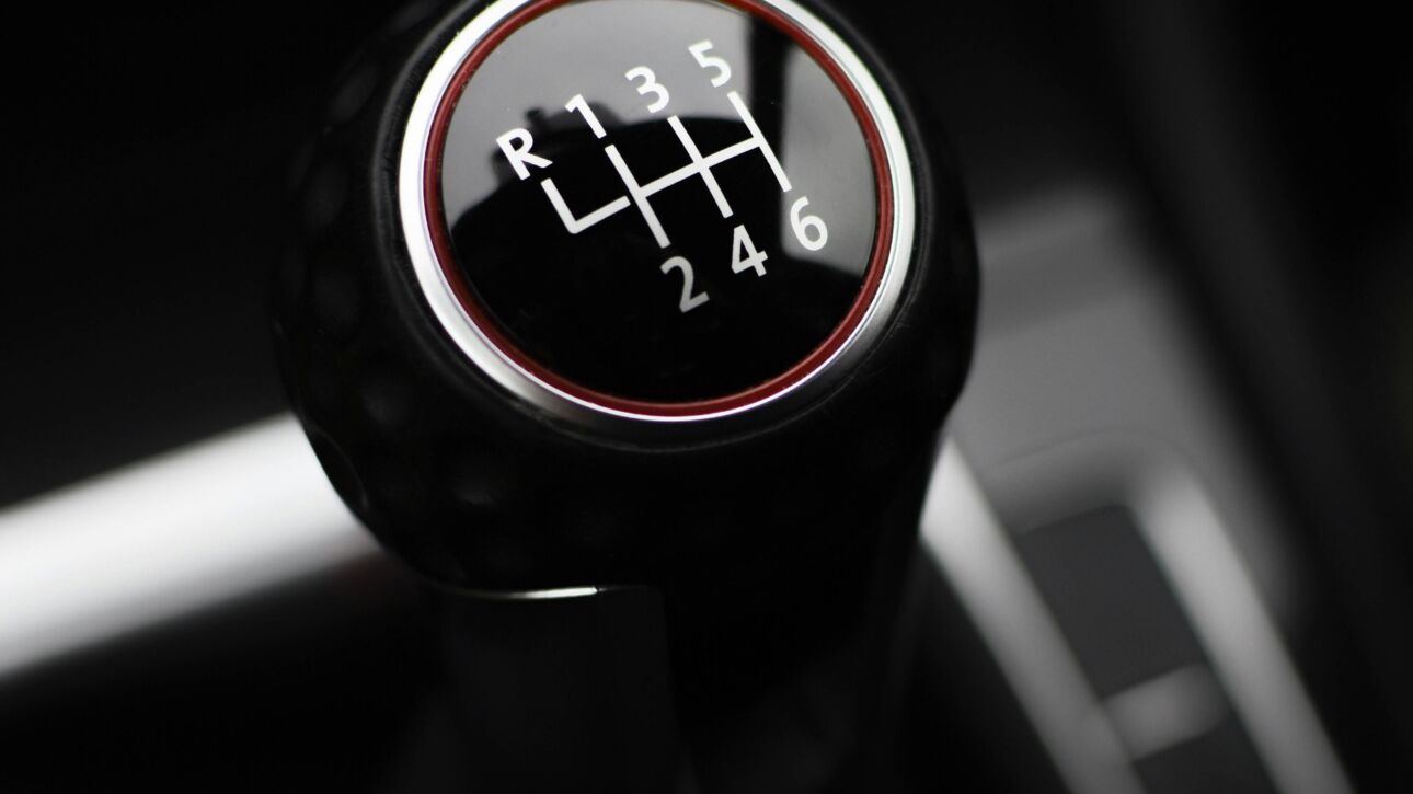 Close-up of a manual gear shift knob in a car