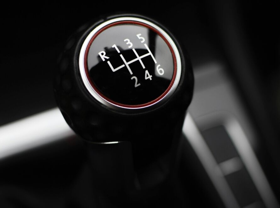 Close-up of a manual gear shift knob in a car