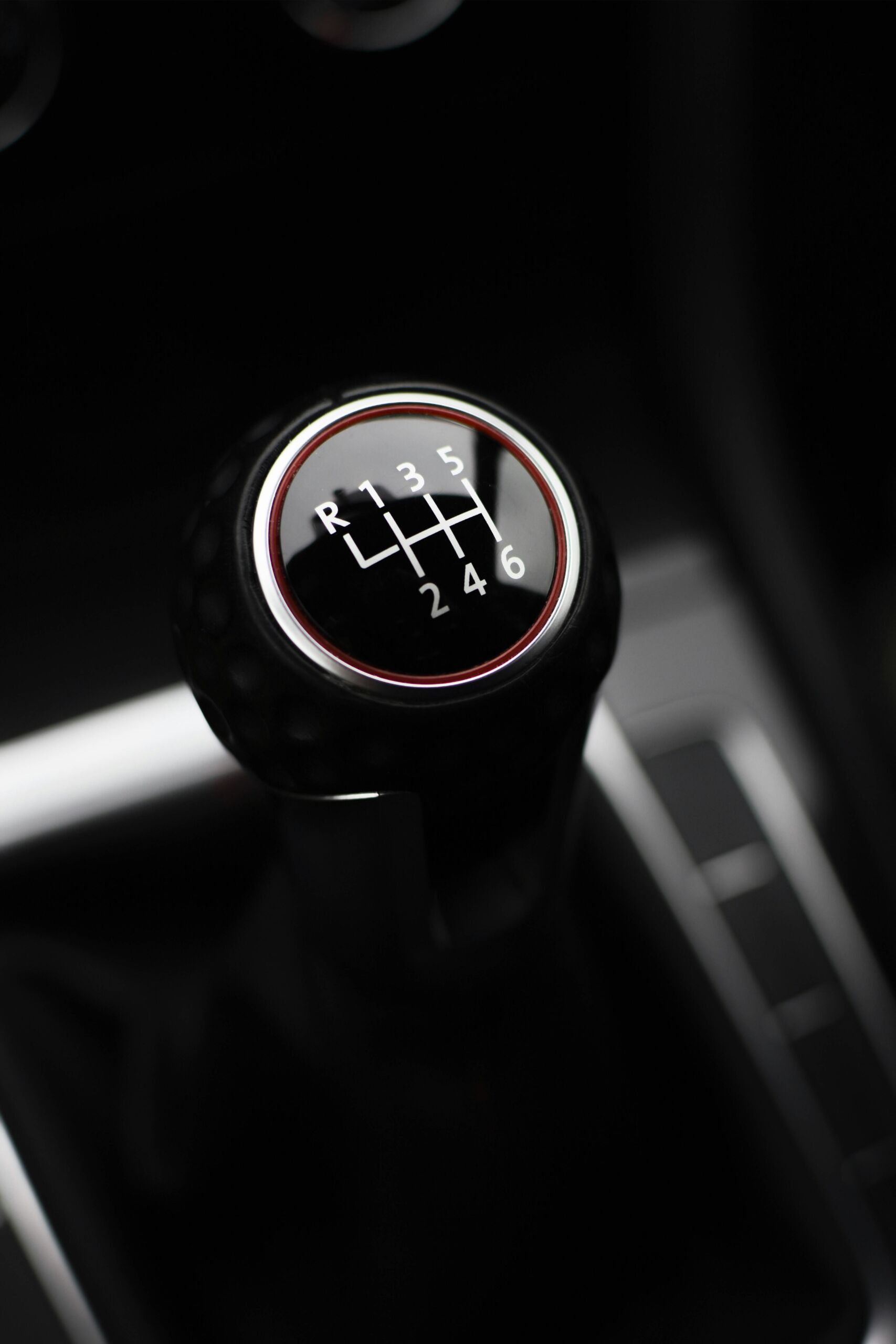 Close-up of a manual gear shift knob in a car