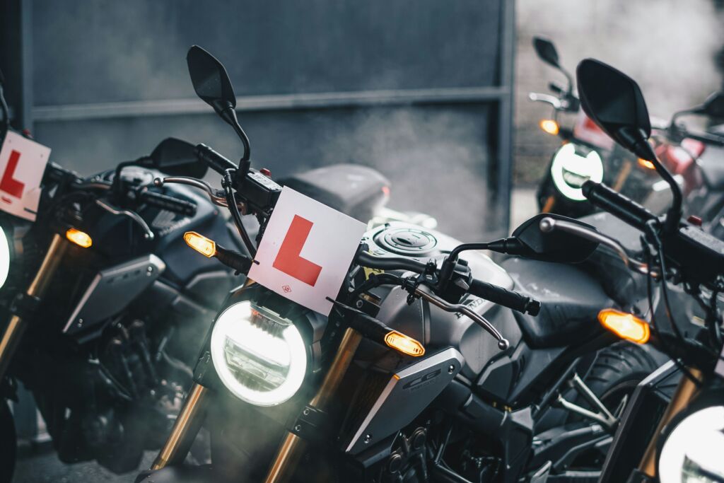 Two motorcycles with L plates parked, showcasing CBT training.